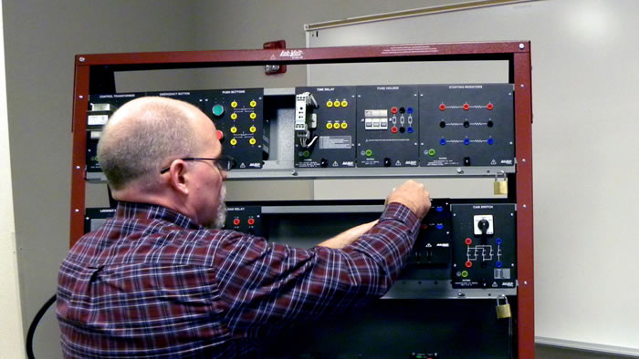 Assistant professor, Jim Hart, inspects equipment that will be used to train students.